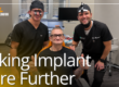 two doctors smiling with patient in dental chair